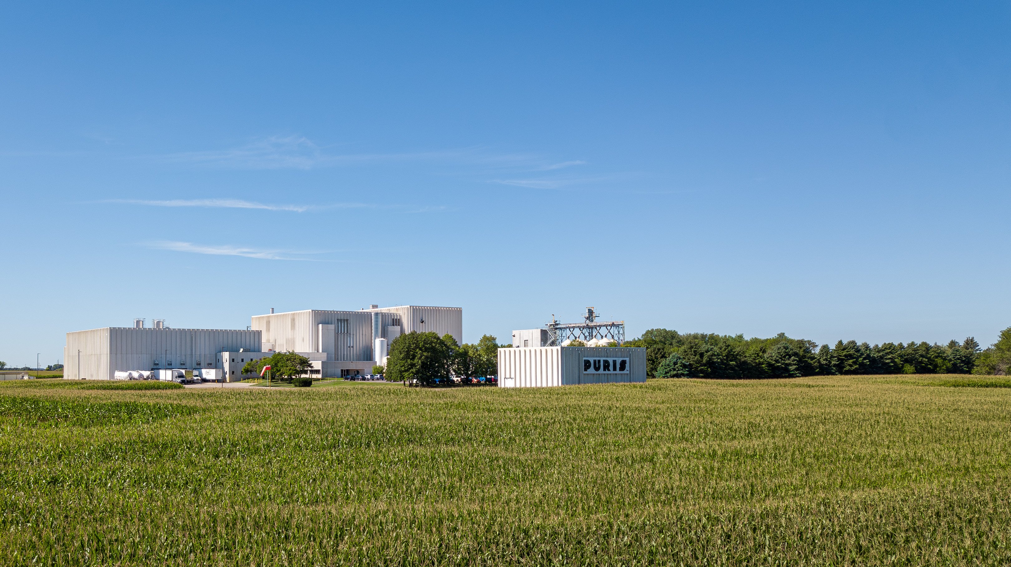 Aerial view of a PURIS organic processing facility beside crop fields